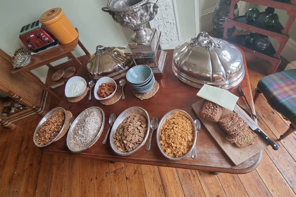 Breakfast cereals, homemade bread, fruit and yoghurt on the table at Temple House