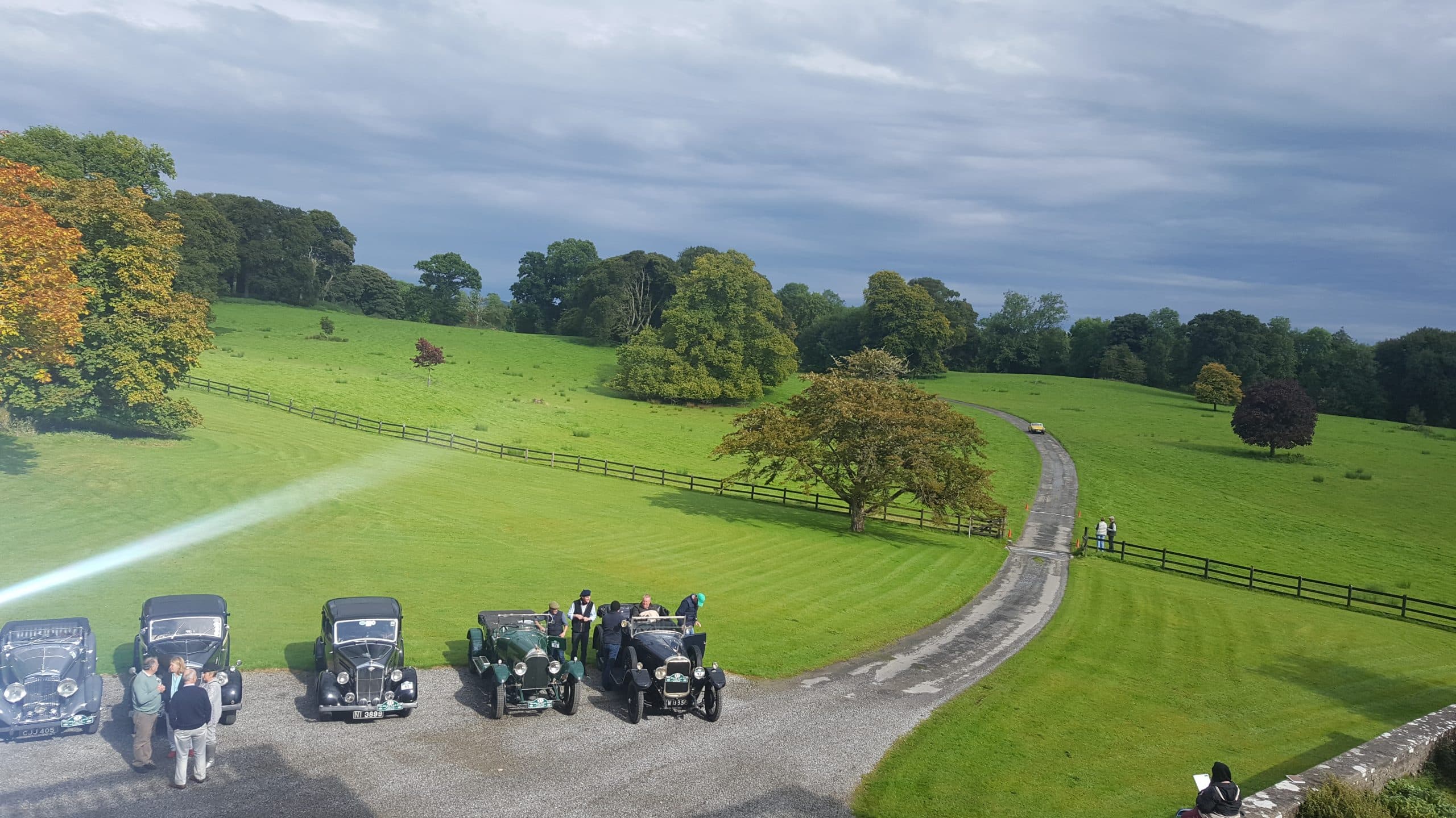 Classic cars on the gravel forecourt at Temple House