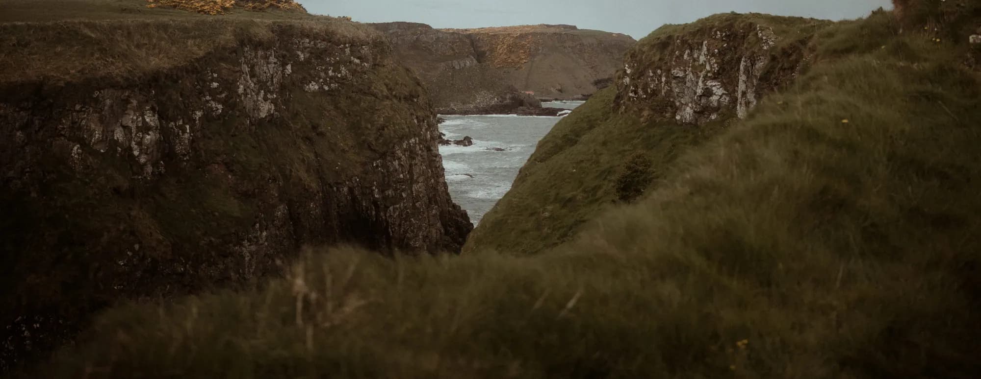 Sea cliffs on the Irish coast, with a narrow inlet of surf between them