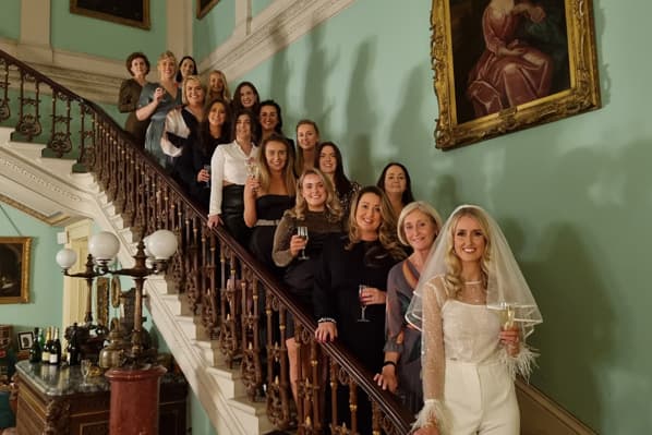 Hen party gathered on the grand staircase at Temple House, County Sligo