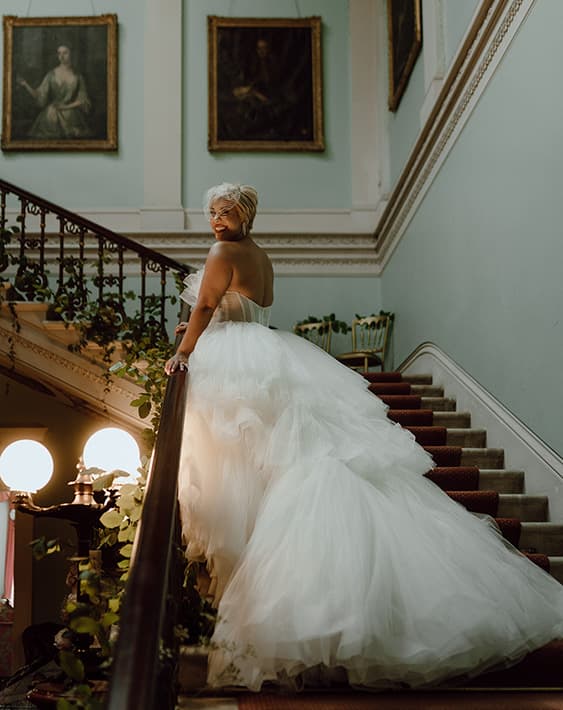 Beautiful bride on the grand staircase who had made contact with Temple House for her wedding