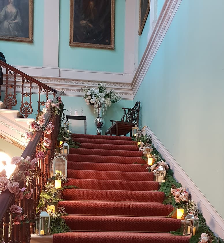 The grand staircase lit for a wedding at Temple House