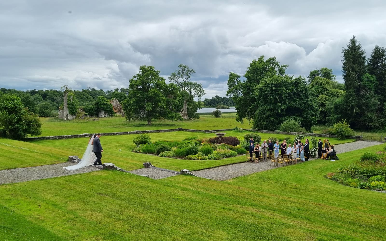 Wedding couple walking down the steps to their ceremony at Temple House