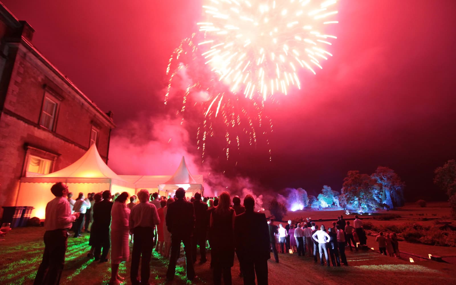 Fireworks over a red sky at a Temple House wedding