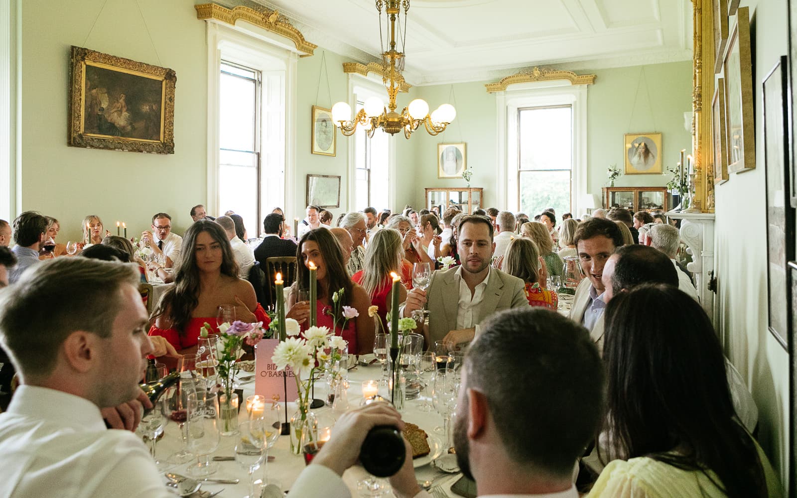 Wedding guests enjoying dinner in the dining room at Temple House