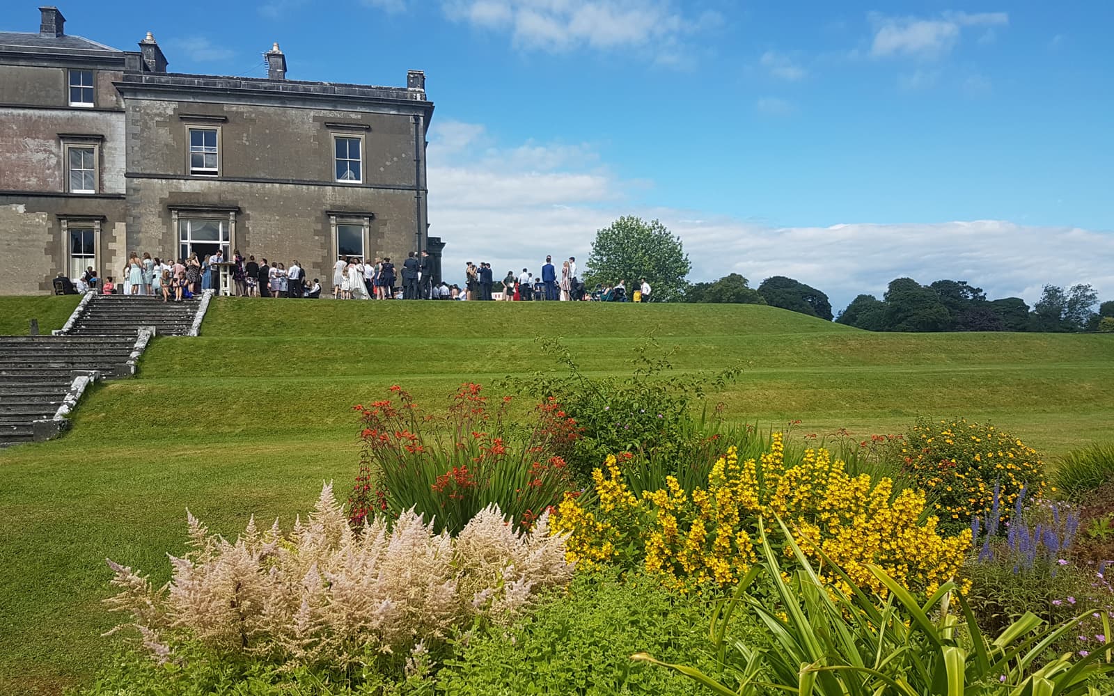 Wedding guests gathered outside Temple House in County Sligo